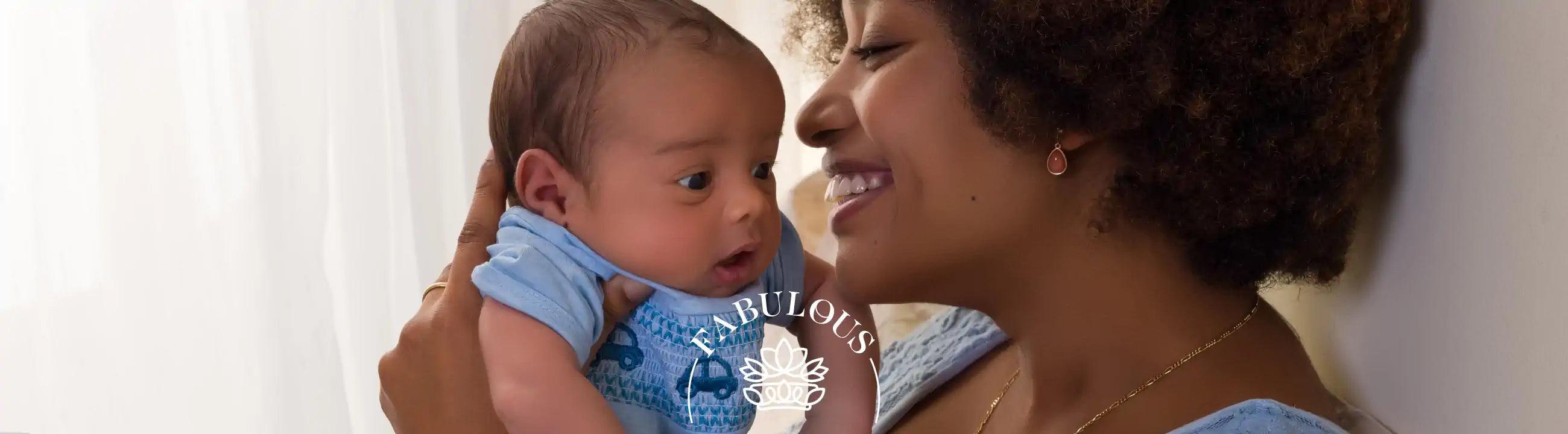 Mother holding and smiling at her baby - Fabulous Flowers and Gifts