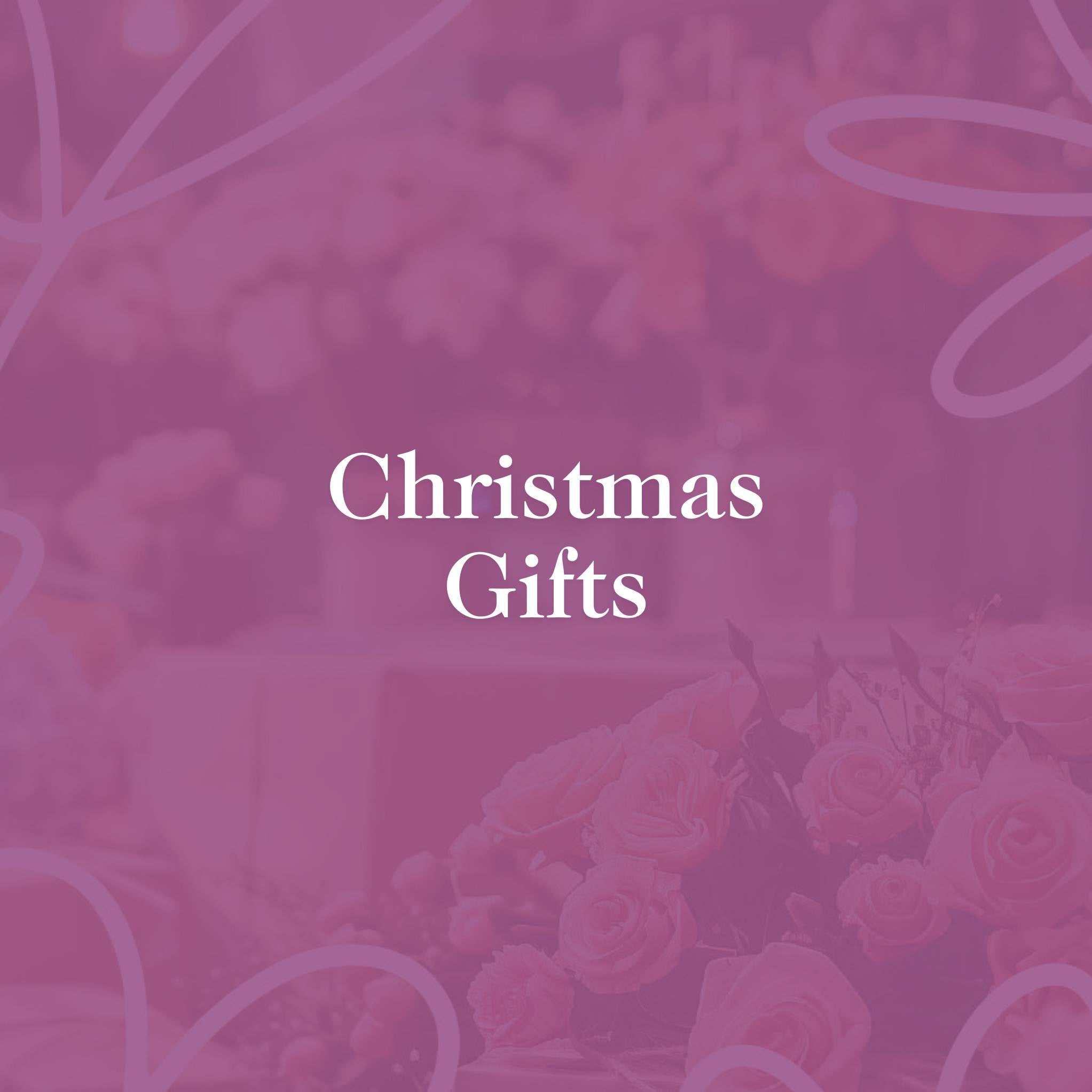 Christmas Gifts text on a festive pink background with soft floral design, promoting seasonal gift offerings at Fabulous Flowers and Gifts