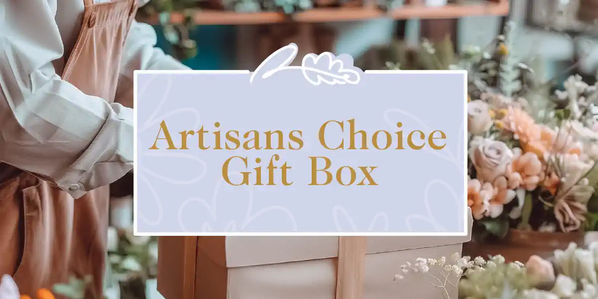Florist creating artisans gift box surrounded by peach and green flowers. Shop the Fabulous Flowers and Gifts collection. 