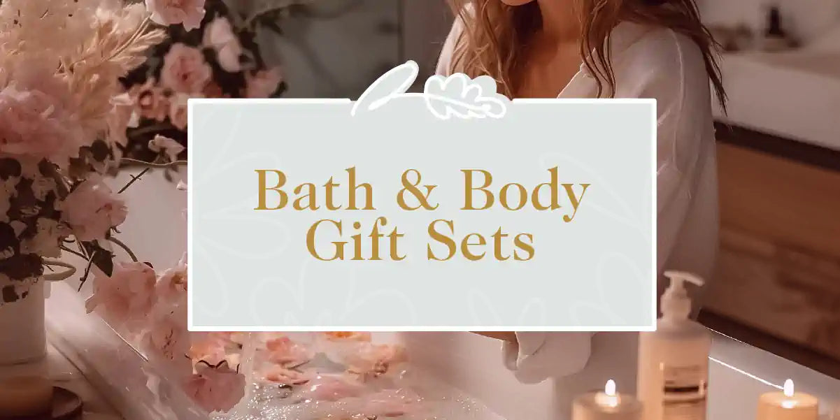 A serene bathroom scene with a woman in a white robe surrounded by floral arrangements and candles, perfect for relaxation. Bath & Body Gift Sets Collection. Fabulous Flowers and Gifts.