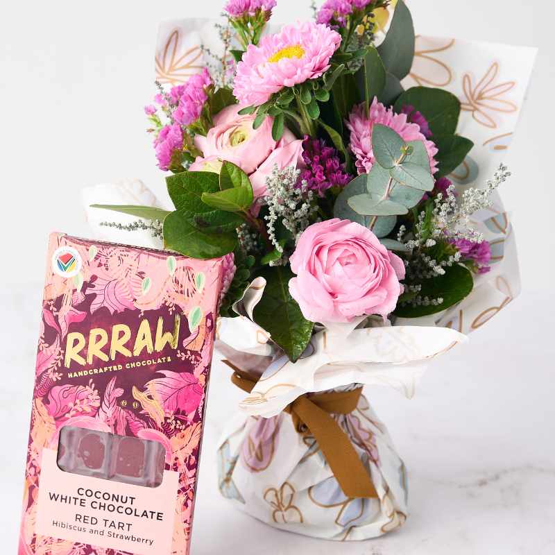 Close-up of Blossom Beauty Posy flower arrangement with RRRRAW handcrafted chocolate, showcasing pink roses, eucalyptus, and fresh flowers in a beautifully wrapped bouquet.