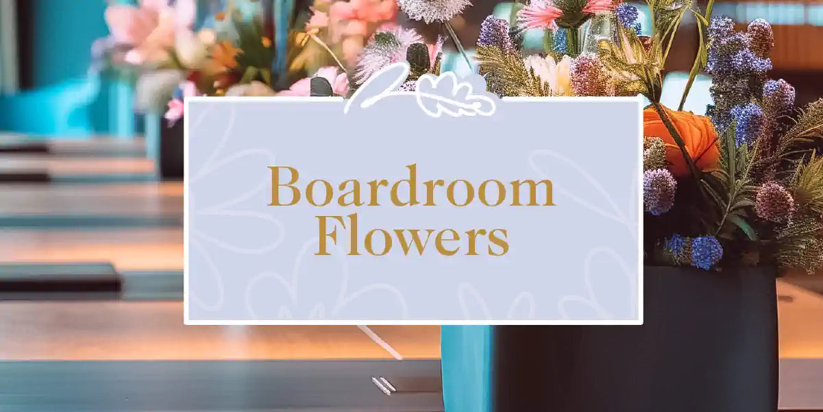 A stylish boardroom adorned with vibrant floral arrangements on the table. Fabulous Flowers and Gifts - Boardroom Flowers