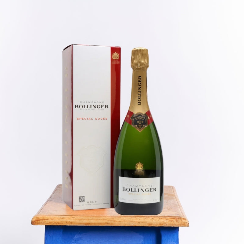 Bollinger Special Cuvée Brut champagne bottle with signature red and white gift box displayed on a wooden table.