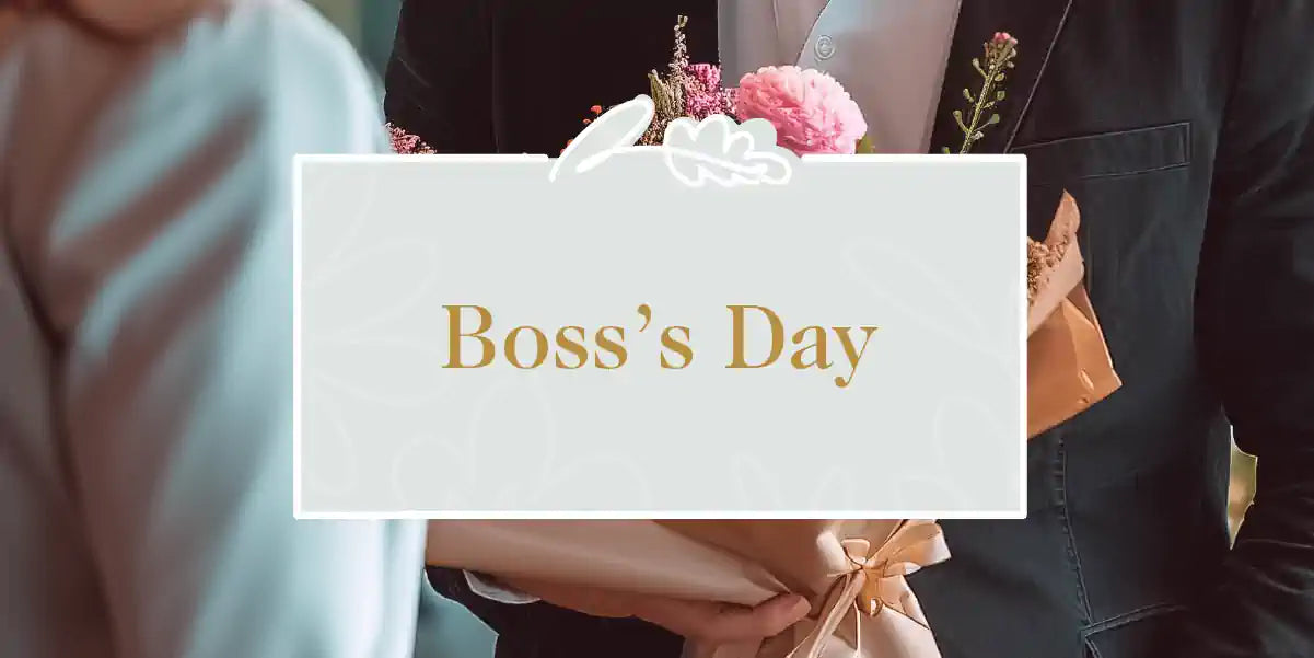 A person in a suit holding a bouquet of flowers wrapped in brown paper, prepared for a Boss's Day celebration. Boss's Day Collection. Fabulous Flowers and Gifts.