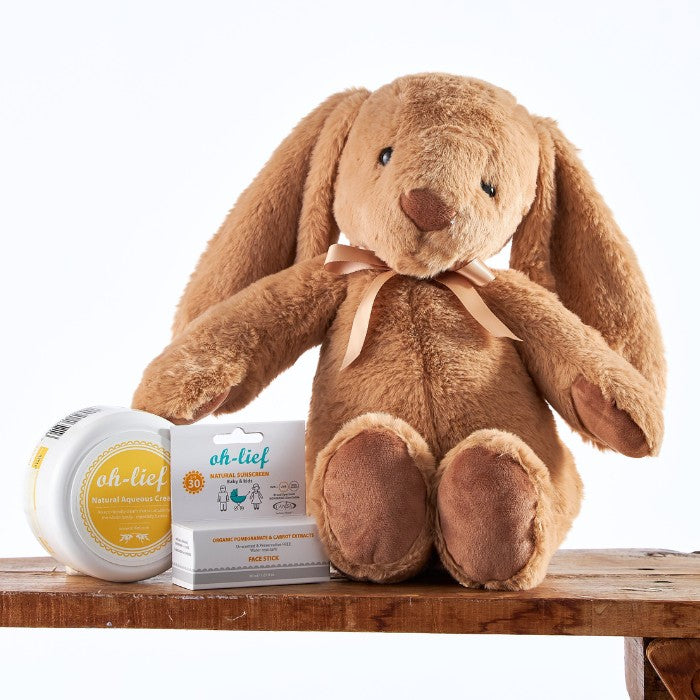 Adorable brown bunny plush with Bunny's Sun Safe Kit including organic SPF products, perfect for child protection.