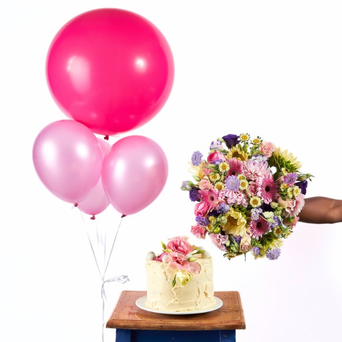 Festive arrangement with pink and light pink balloons, a buttercream cake adorned with flowers, and a vibrant floral bouquet.