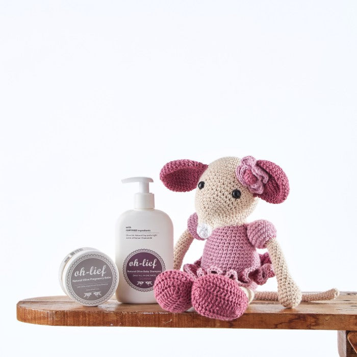 Cuddle Mouse Wellness Pack featuring a handmade pink crochet mouse alongside natural olive baby shampoo and organic pregnancy balm.