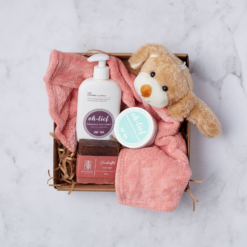 Cuddle and Care Gift Box featuring natural baby products and a soft plush toy for gentle care. Perfect for new parents.