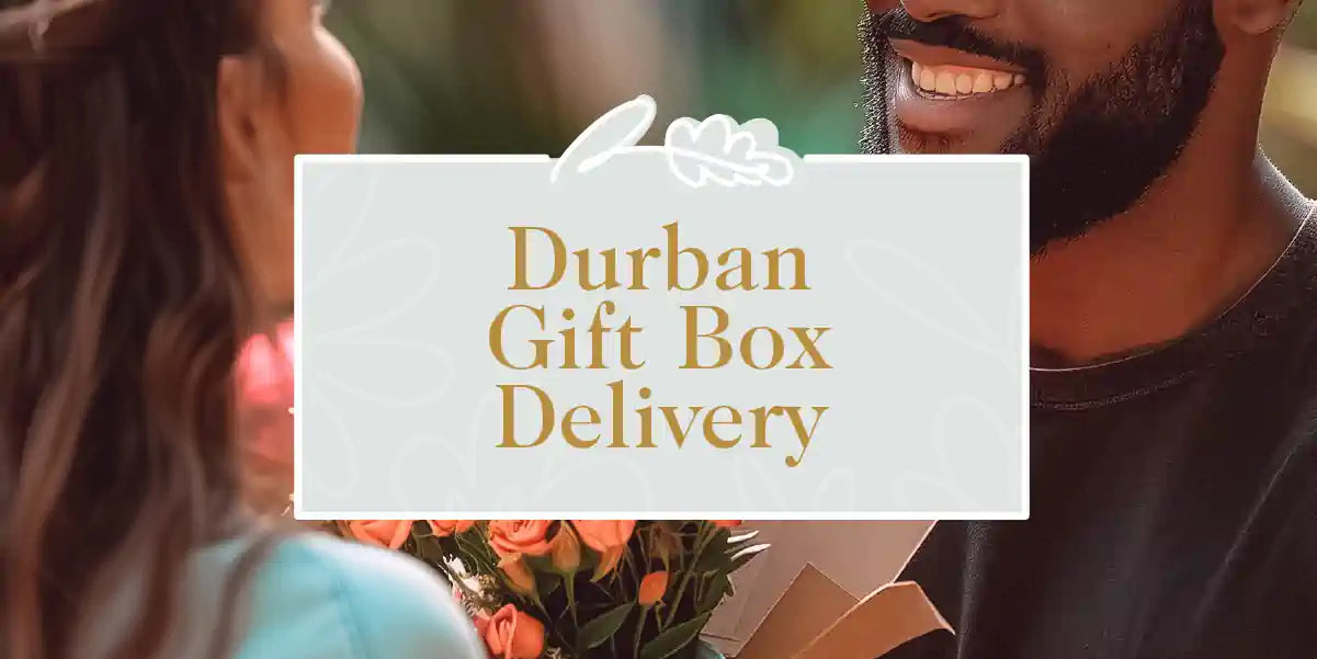 Durban Gift Box Collection: A smiling man holding a gift box with a bouquet of orange roses, presented to a woman. Fabulous Flowers and Gifts.