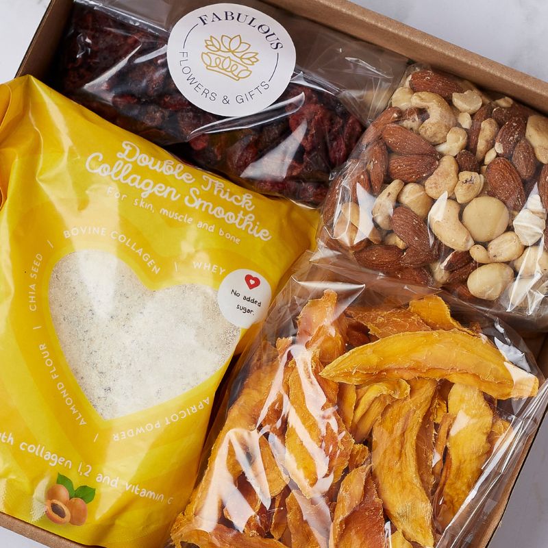 Top view of a Fabulous Wellness Delight Gift Box with collagen smoothie, dried fruits, and mixed nuts.