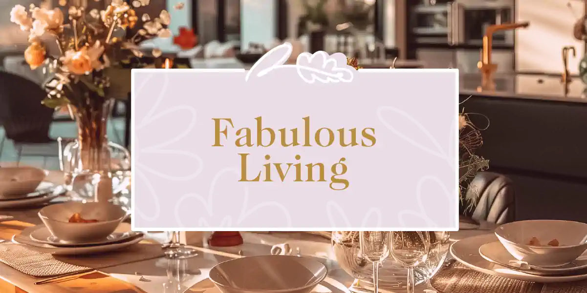 Fabulous Living Collection: Elegant dining setup with fine china, wine glasses, and a vibrant floral centrepiece, enhancing a modern kitchen. Fabulous Flowers and Gifts.