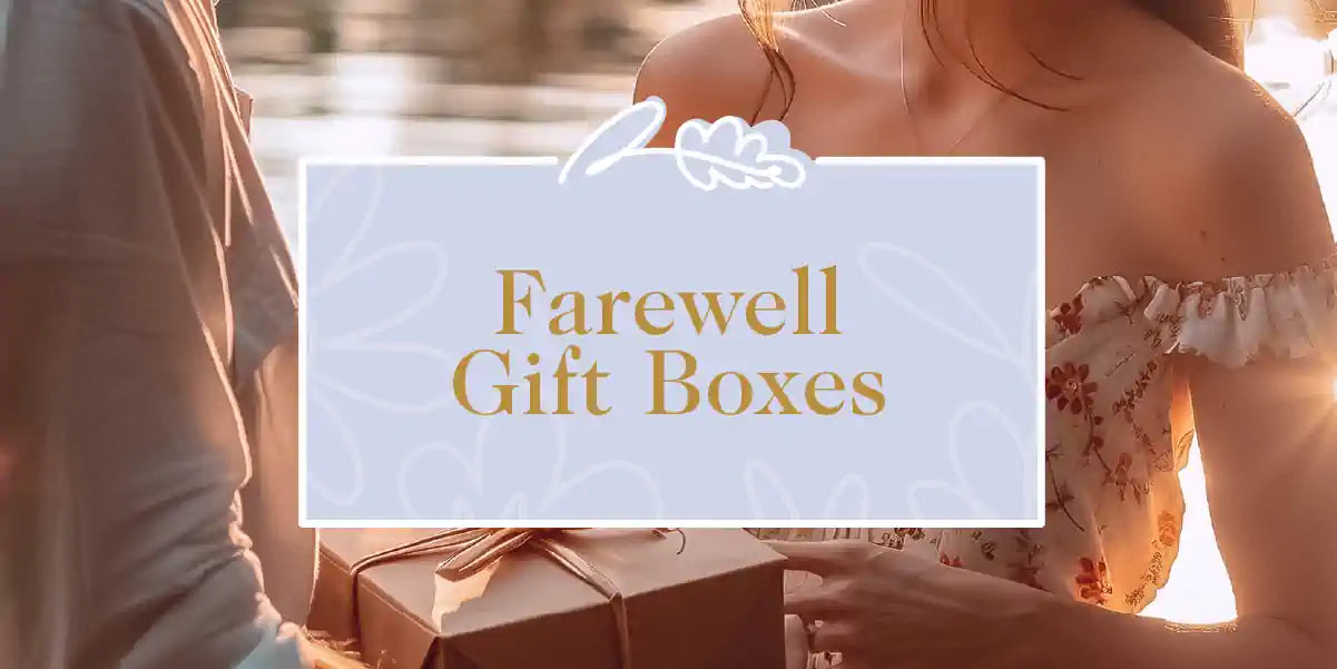 Two people exchanging a beautifully wrapped gift box during a farewell event. Fabulous Flowers and Gifts - Farewell Gift Boxes