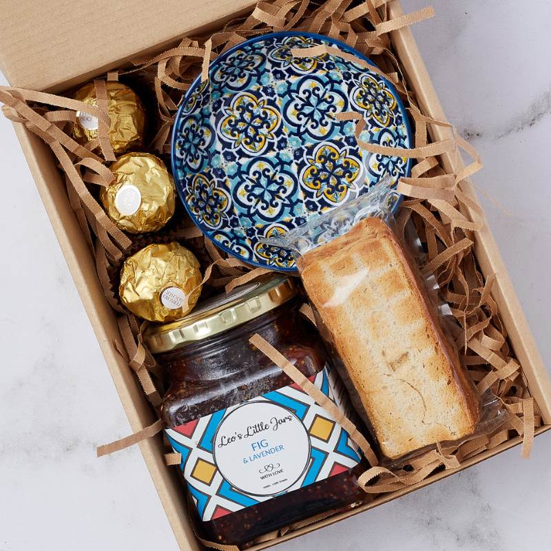 Close-up of the Fig and Lavender Delight Gift Box with fig and lavender jam, decorative bowl, and Ferrero Rocher chocolates.