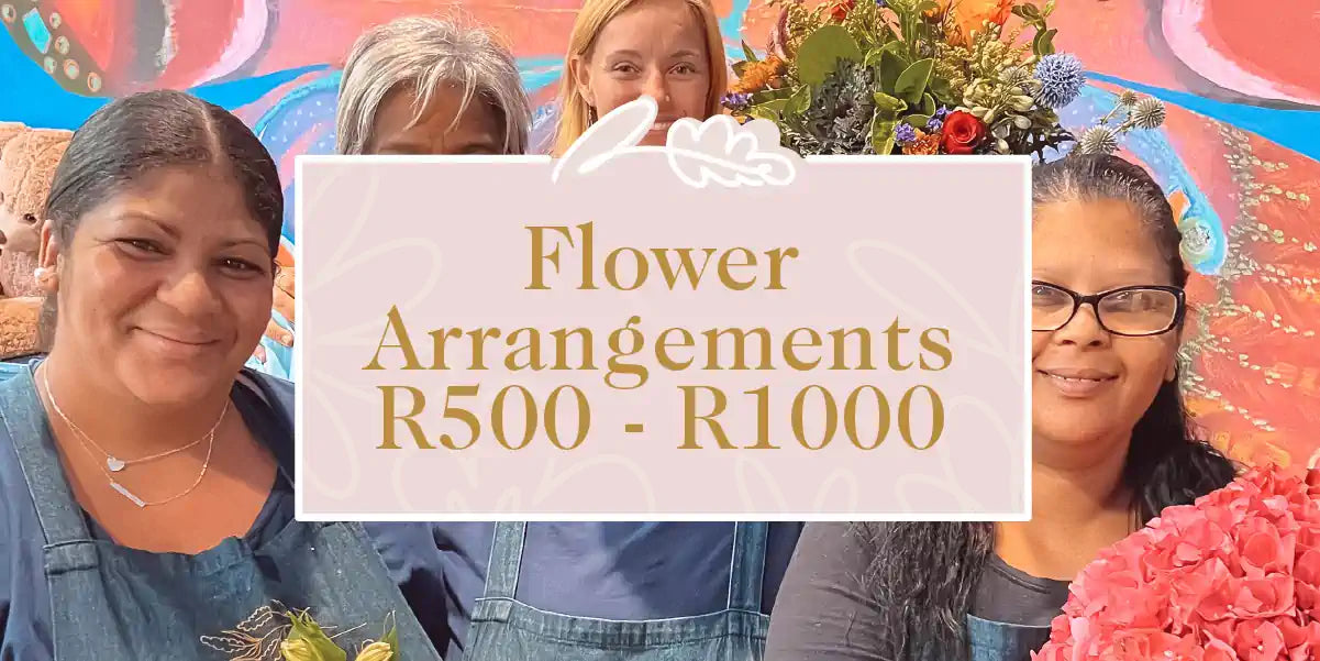 A group of florists proudly displaying their beautiful flower arrangements, priced between R500 and R1000. Fabulous Flowers and Gifts - Flower Arrangements R500 - R1000