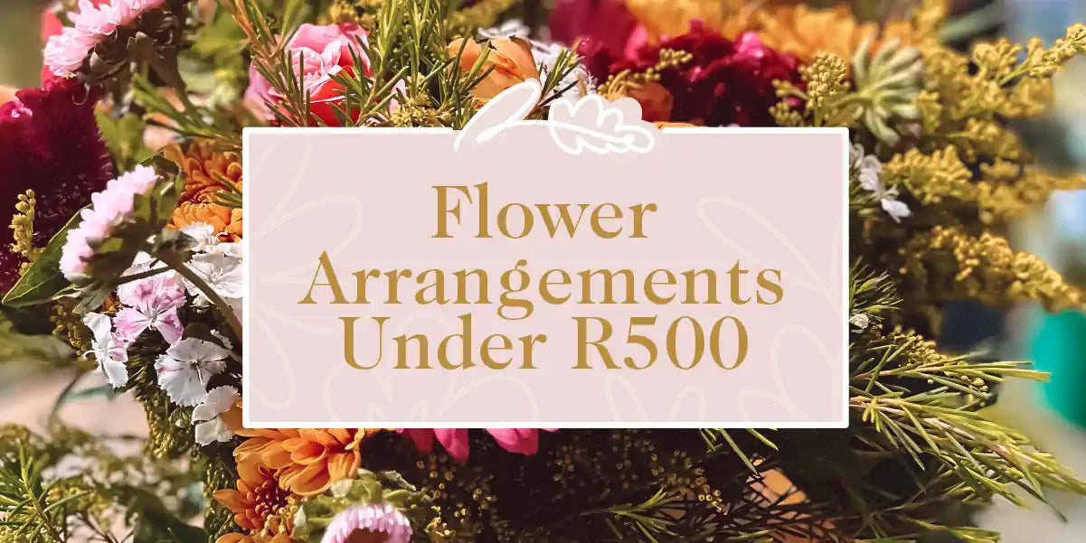 A vibrant bouquet of mixed flowers featuring pink, orange, and white blossoms against a lush green background. Fabulous Flowers and Gifts - Flower Arrangements Under R500
