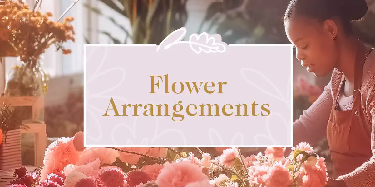 A florist arranging a stunning display of pink roses and chrysanthemums in a well-lit flower shop. Fabulous Flowers and Gifts - Flower Arrangements