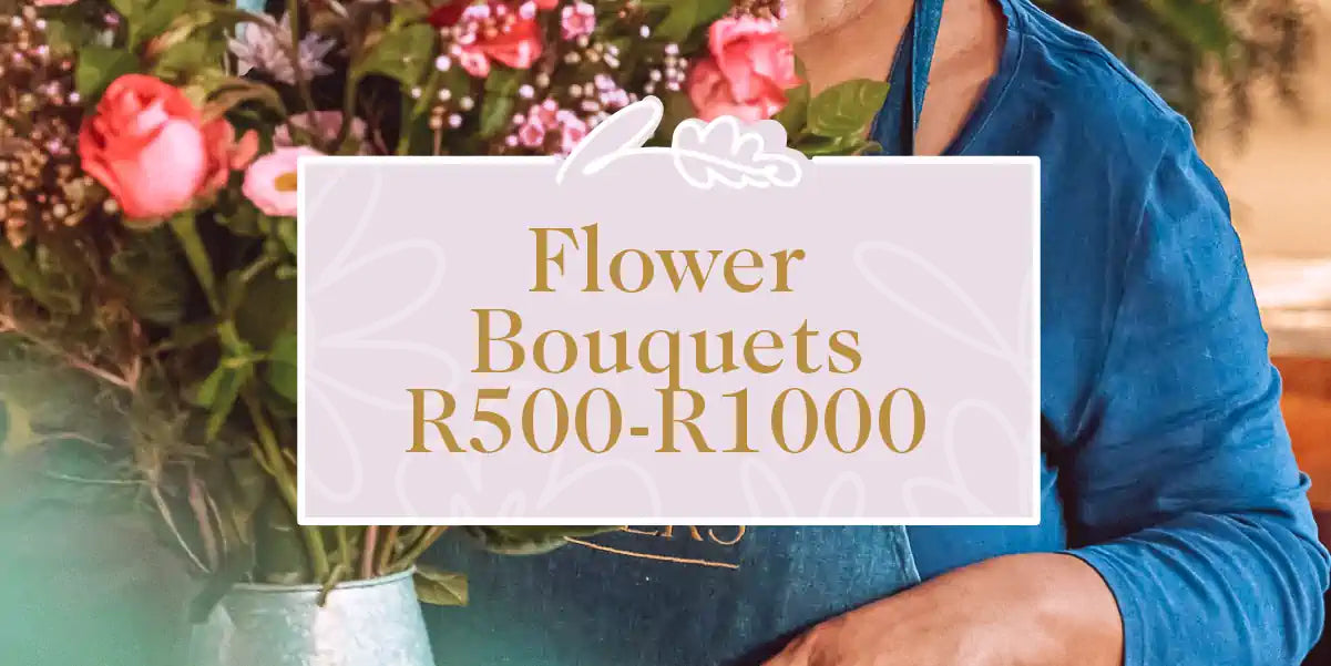 A florist holding a large bouquet of roses and greenery. Fabulous Flowers and Gifts - Flower Bouquets R500-R1000