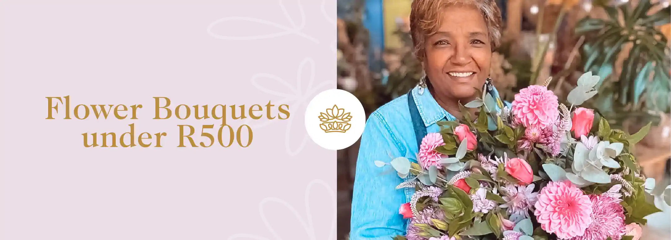 A delighted South African florist in a blue denim jacket holding a lush bouquet of pink dahlias and other mixed flowers, showcasing affordable yet exquisite options from the Flower Bouquets under R500 Collection. Fabulous Flowers and Gifts.