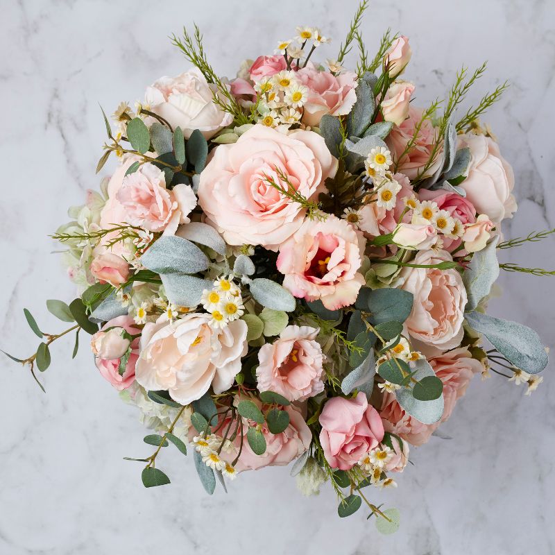 Top view of the Forever Blush artificial flower arrangement with pink roses, peonies, white daisies, and eucalyptus greenery.