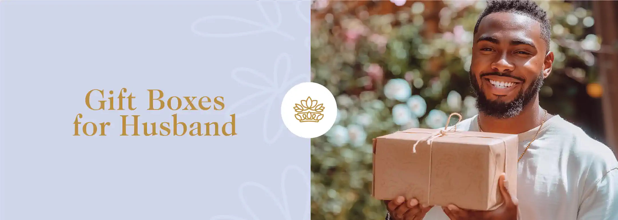 A smiling man holding a wrapped gift box, perfect for a husband’s special occasion. Fabulous Flowers and Gifts - Gift Boxes for Husband