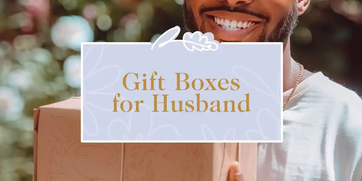 A happy husband holding a gift box with a bright smile on his face. Fabulous Flowers and Gifts - Gift Boxes for Husband