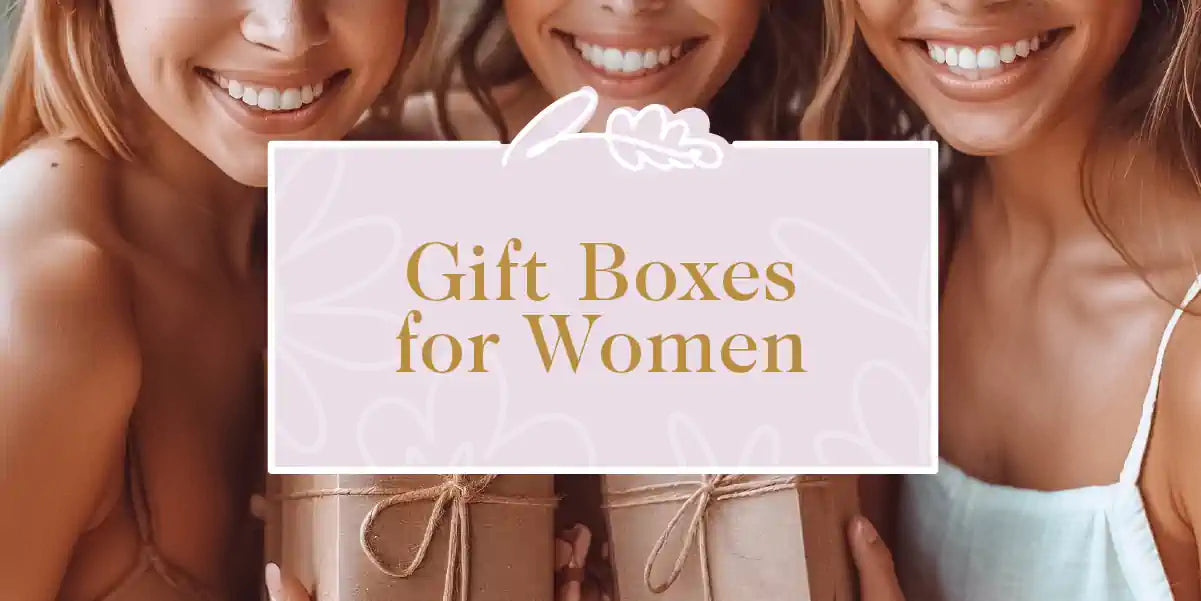 Three women happily showing their gift boxes tied with elegant ribbons, with their bright smiles and casual attire. Fabulous Flowers and Gifts - Gift Boxes for Women