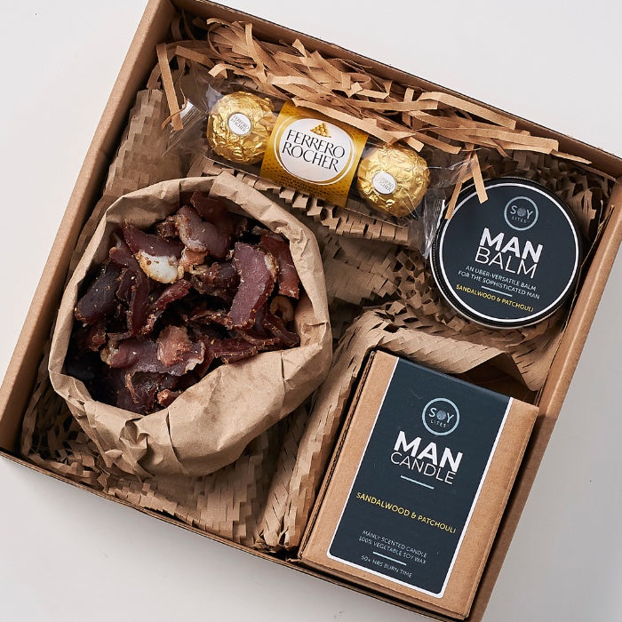 Full view of Gifts for a Man Hamper presented in a rustic gift box filled with Ferrero Rocher chocolates, premium dried meat, a sandalwood and patchouli scented man candle, and man balm.