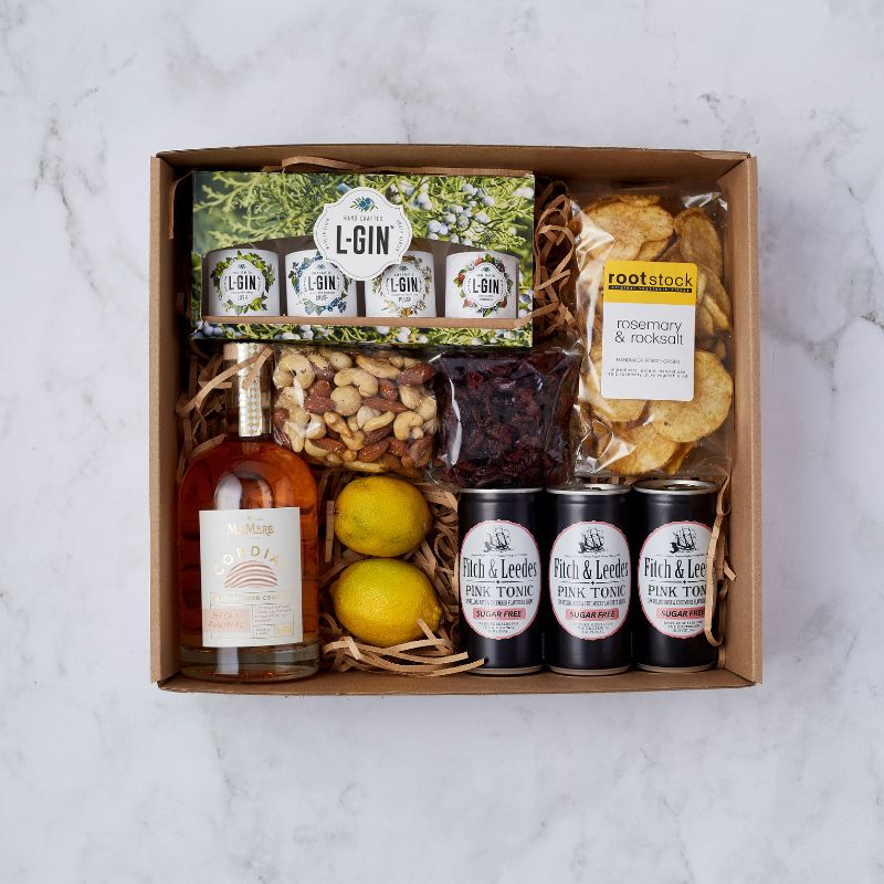 Gin gift box with L-GIN, tonic cans, mixed nuts, lemons, and gourmet crisps for the ultimate cocktail experience.