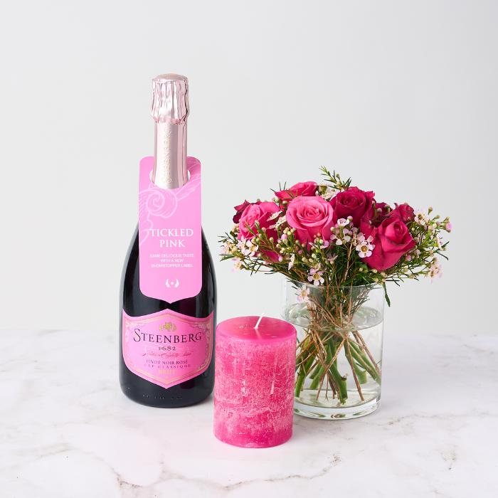 Girl of Now Gift Set with Steenberg Pinot Noir Rosé, pink rose bouquet in glass vase, and pink candle.