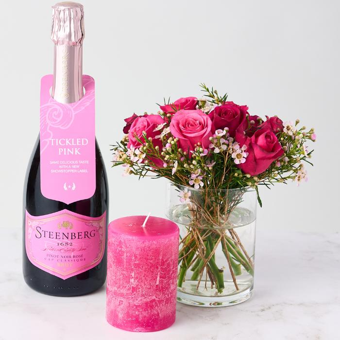 Girl of Now Gift Set featuring Steenberg Pinot Noir Rosé, a bouquet of pink roses, and a pink candle.