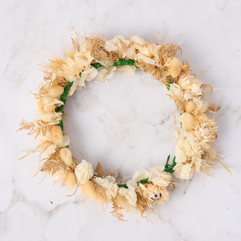 Beige dried flower crown with soft golden tones and delicate fern accents.