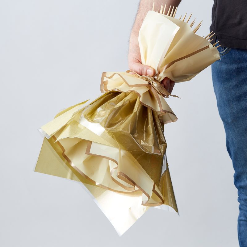 Back view of the Ferrero Rocher bouquet in gold wrapping, showcasing the bouquet's intricate design.