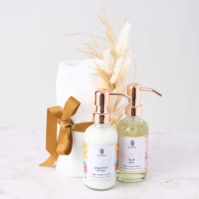 Golden Touch Pamper Gift Set with hand & body lotion, body wash, and rolled towel. Perfect for luxurious self-care gifts.