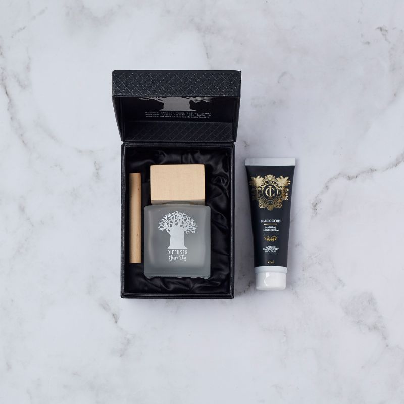 Gift set featuring Mockana green fig diffuser and Cape Island Black Gold hand cream, presented in an elegant black box.