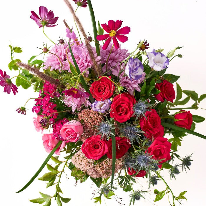 Overhead view of Gucci Grande Flower Arrangement with a vibrant mix of roses and cosmos.