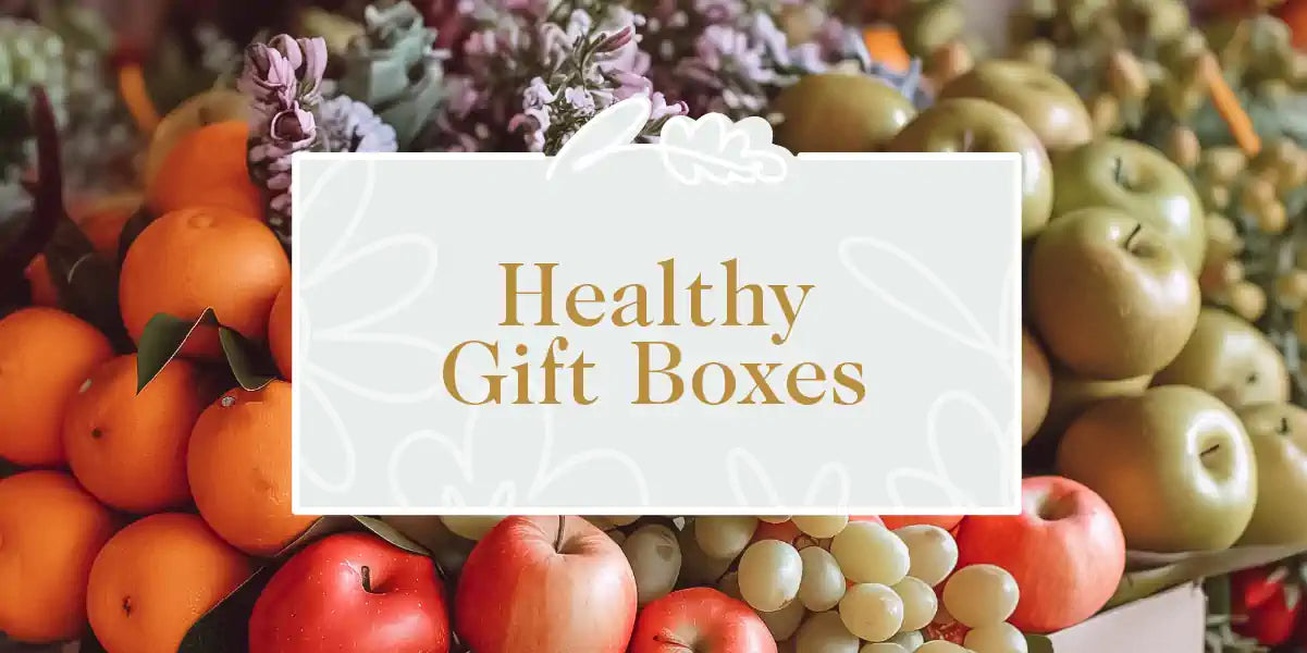 A vibrant assortment of fresh fruits including oranges, apples, and grapes displayed with succulent plants. Fabulous Flowers and Gifts - Healthy Gift Boxes