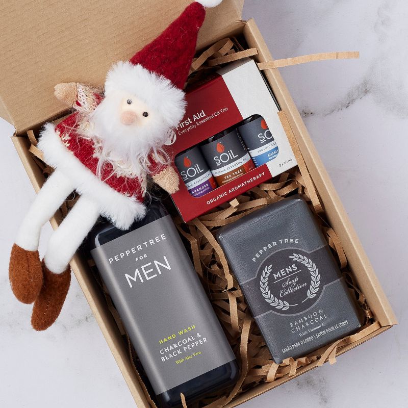 Holiday Gentleman’s Care Package featuring Peppertree for Men hand wash, bamboo charcoal soap, essential oils, and festive plush.