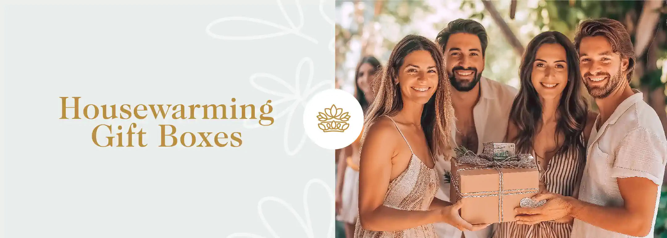 Two joyful couples presenting a housewarming gift box, sharing smiles and happiness at a festive gathering, ideal for celebrating new beginnings. Featured in the Housewarming Gift Boxes Collection at Fabulous Flowers and Gifts.