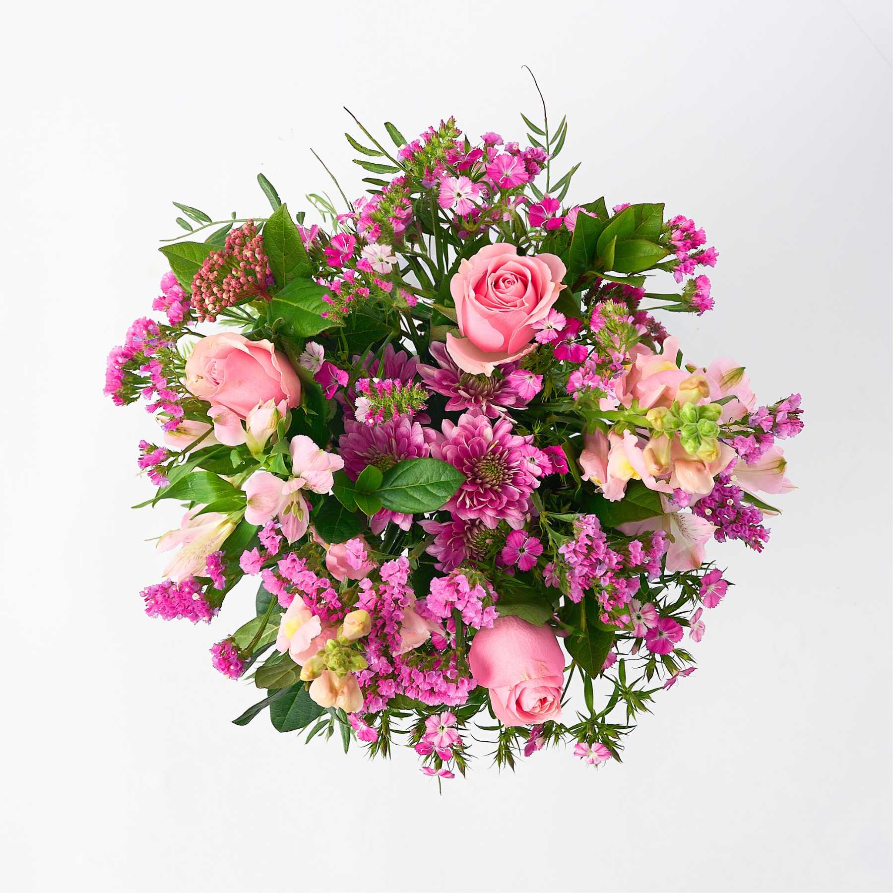 Top view of the 'Joy in a Jar' flower arrangement, showcasing an assortment of pink blooms and lush green foliage, perfectly arranged in a glass jar.