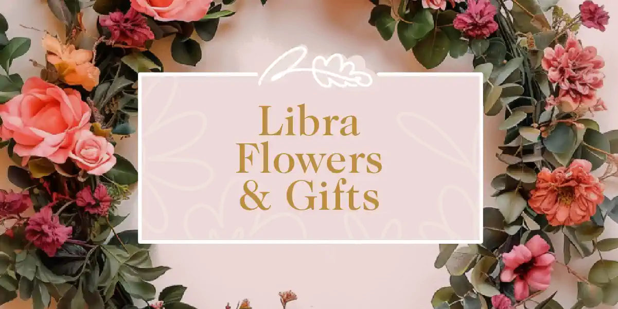 A beautiful floral wreath with pink and red flowers, perfect for celebrating the Libra star sign. Fabulous Flowers and Gifts - Libra Flowers & Gifts