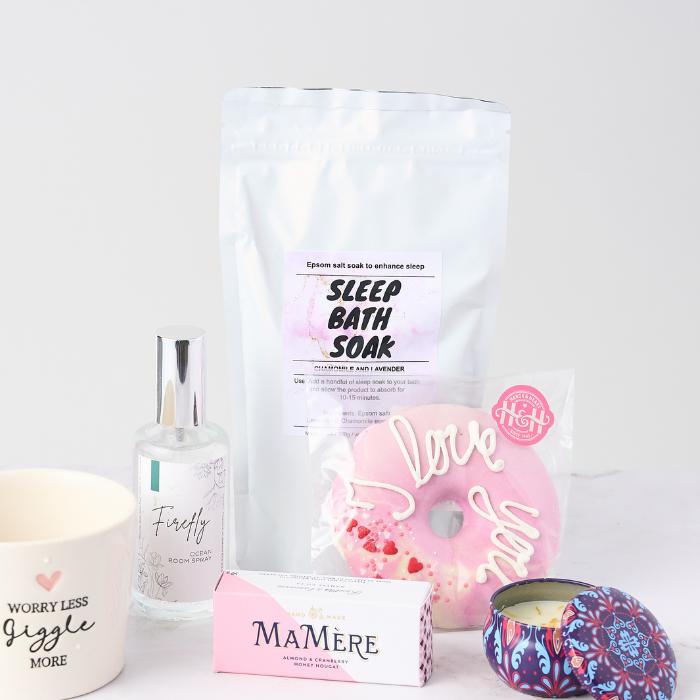 Lovely Lady Gift Set items including sleep bath soak, room spray, donut-shaped bath bomb, nougat treat, and decorative candle tin.