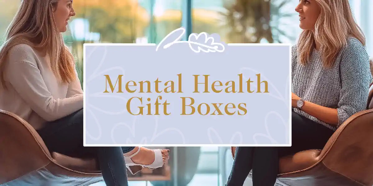 Two women having a conversation in a modern setting, with a mental health gift box in the foreground. Fabulous Flowers and Gifts - Mental Health Gift Boxes