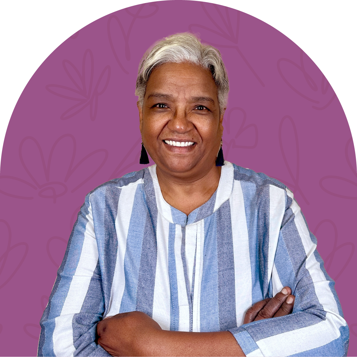 Portrait of Mymoena, a dedicated team member at Fabulous Flowers for nearly 3 years, wearing a blue and white striped shirt and standing against a purple background. MEET THE TEAM at Fabulous Flowers and Gifts.