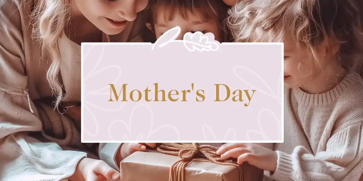 A heartwarming moment as a mother and her children gather around a beautifully wrapped gift for Mother's Day. Fabulous Flowers and Gifts - Mother's Day