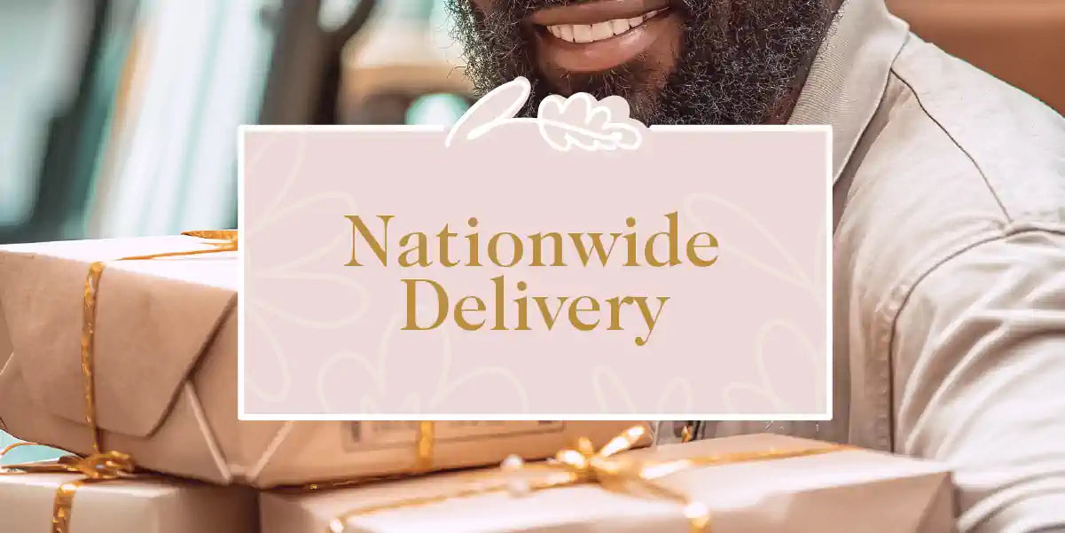 Nationwide Delivery Collection: A smiling man holding several beautifully wrapped gift boxes with gold ribbons, ready for delivery. Fabulous Flowers and Gifts.