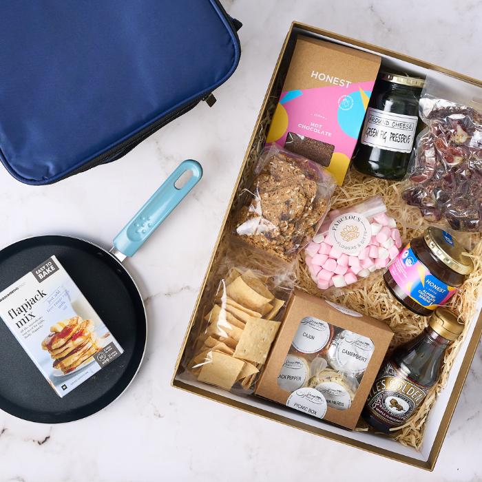 Nice to Treat You Gift Set featuring flapjack mix, non-stick pan, cheese box, crackers, hot chocolate, fig preserve, pink marshmallows, and golden syrup.