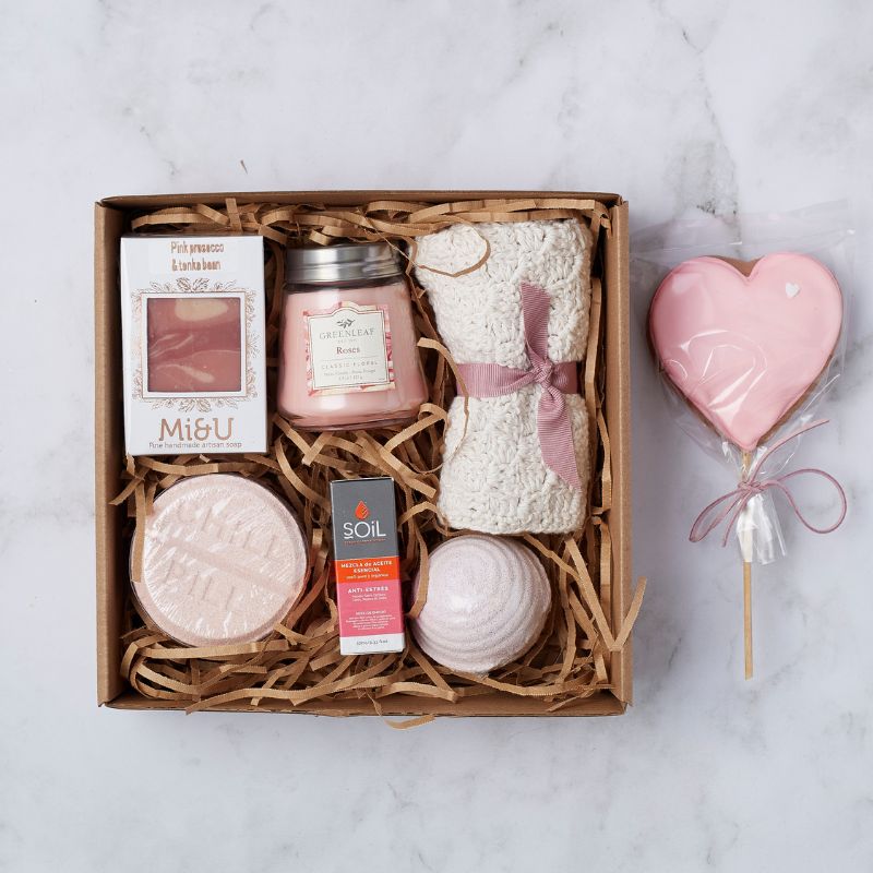 Pamper gift box with Greenleaf rose candle, Mii & U artisan soap, bath towel, bath bomb, essential oil, and heart-shaped treat.