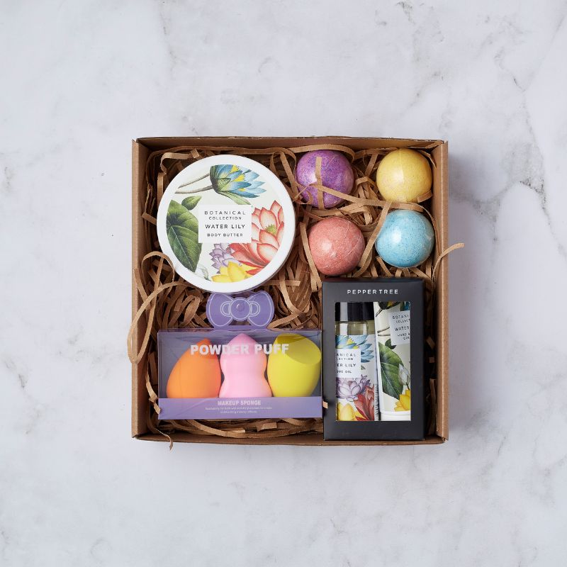 Gift box with Water Lily body butter, colourful makeup sponges, botanical hand cream, bath bombs, and essential oil