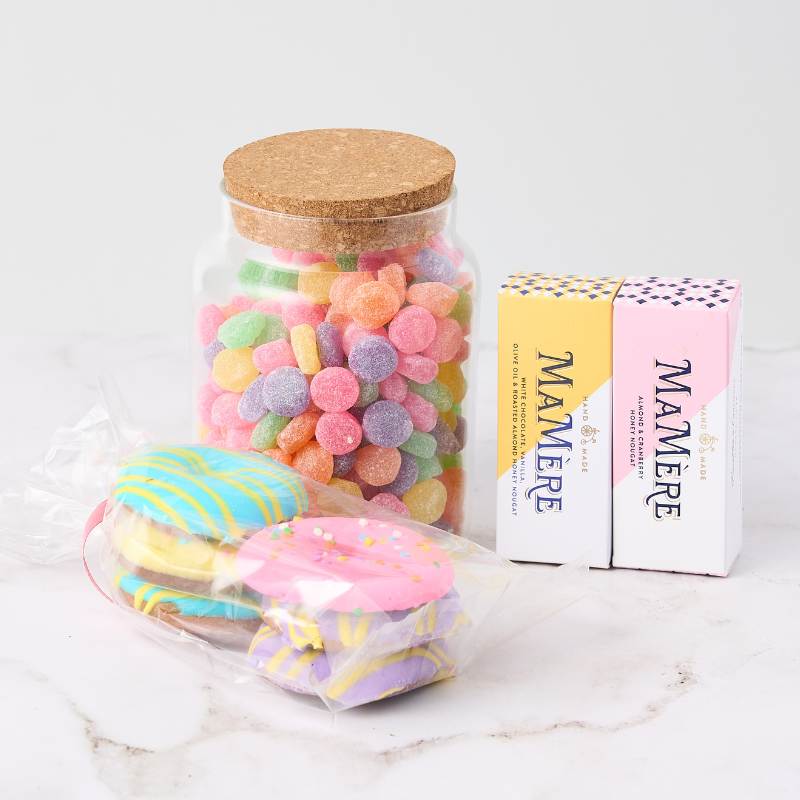 Pastel Pleasures Hamper featuring a jar of colourful gummies, two Mamere nougat bars, and pastel chocolate discs. Perfect sweet treat gift.