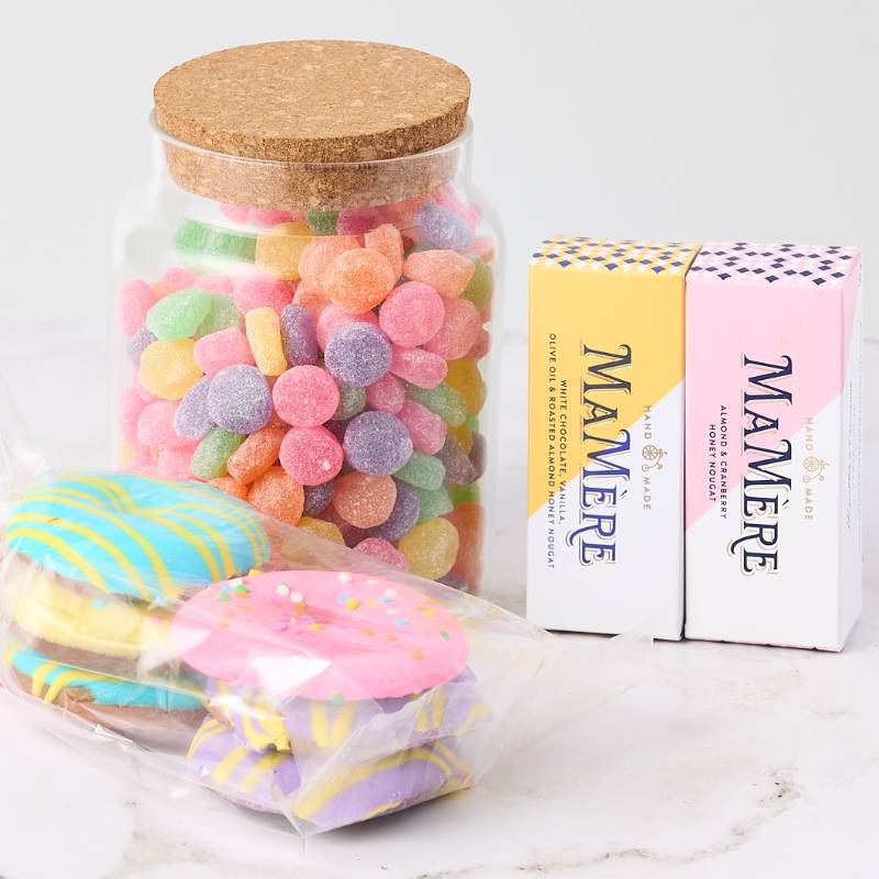 Pastel Pleasures Hamper with assorted gummy sweets, almond and honey nougat, and pastel chocolate discs. A delightful gift for any occasion.